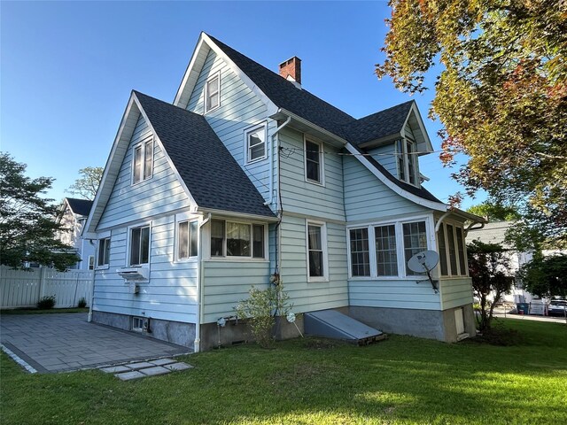 22 Herbert St, Beacon, NY 12508 - back of property with a patio area, a chimney, and a shingled roof