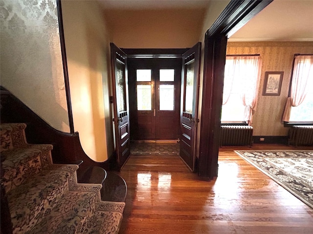 22 Herbert St, Beacon, NY 12508 - corridor featuring wood finished floors, radiator heating unit, and stairs