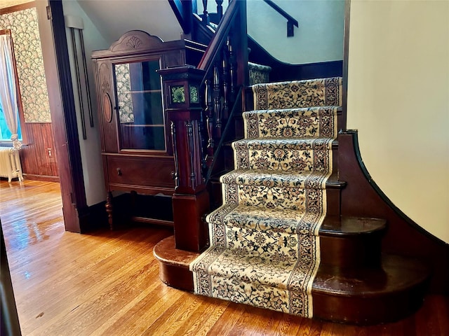 22 Herbert St, Beacon, NY 12508 - stairway with radiator heating unit, wood finished floors, and vaulted ceiling