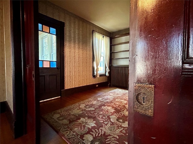22 Herbert St, Beacon, NY 12508 - unfurnished room featuring wood finished floors, wallpapered walls, baseboards, and radiator