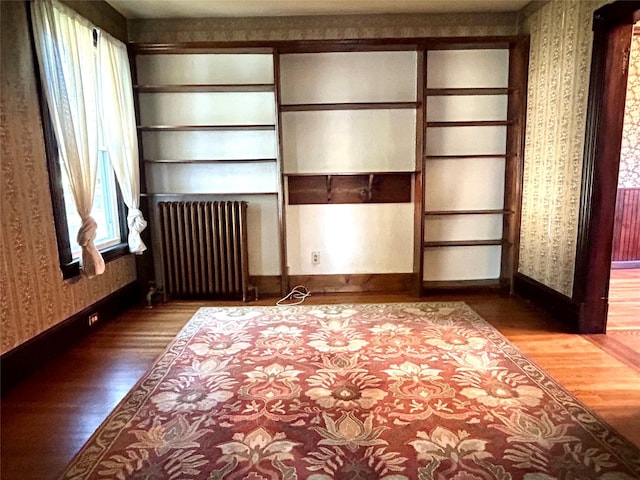 22 Herbert St, Beacon, NY 12508 - unfurnished bedroom with radiator heating unit, wallpapered walls, wood finished floors, and baseboards