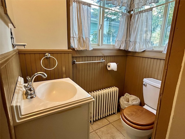 22 Herbert St, Beacon, NY 12508 - bathroom with radiator, wainscoting, plenty of natural light, toilet, and tile patterned floors