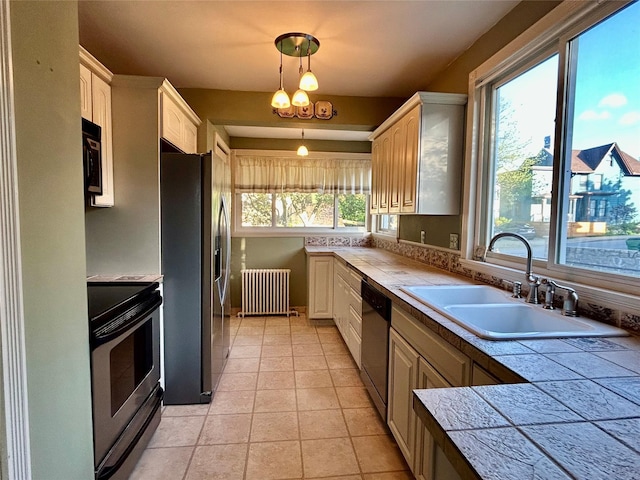 22 Herbert St, Beacon, NY 12508 - kitchen with appliances with stainless steel finishes, a sink, radiator heating unit, light tile patterned flooring, and tile counters