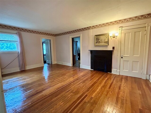 22 Herbert St, Beacon, NY 12508 - unfurnished living room featuring a fireplace, wood finished floors, and baseboards