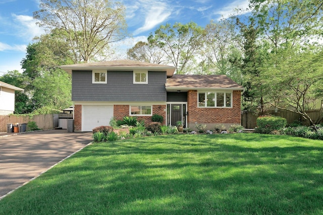 24 Harvard Ln, Commack, NY 11725 - tri-level home featuring concrete driveway, an attached garage, and brick siding