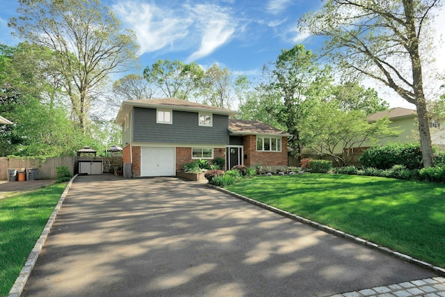 24 Harvard Ln, Commack, NY 11725 - tri-level home featuring driveway, brick siding, a gate, and an attached garage