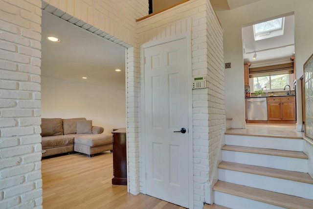 24 Harvard Ln, Commack, NY 11725 - staircase featuring a skylight, wood finished floors, and recessed lighting