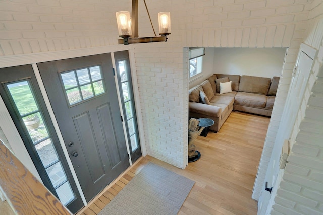 24 Harvard Ln, Commack, NY 11725 - entryway with healthy amount of natural light, wood finished floors, and a chandelier