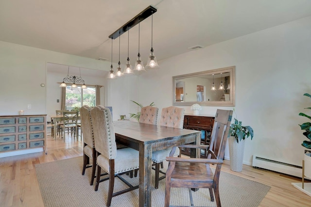 24 Harvard Ln, Commack, NY 11725 - dining room featuring a baseboard heating unit and light wood-style flooring