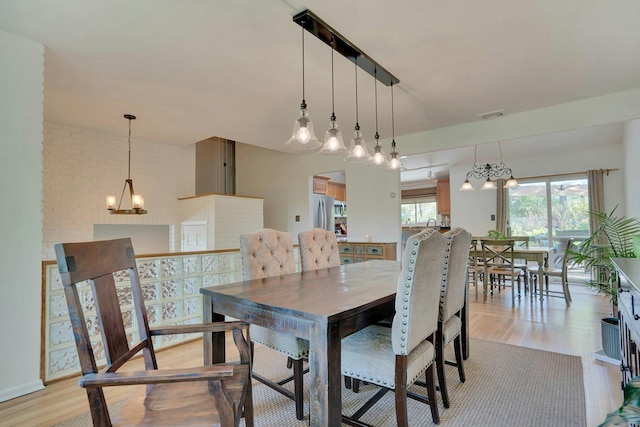 24 Harvard Ln, Commack, NY 11725 - dining space with a chandelier and light wood-style flooring