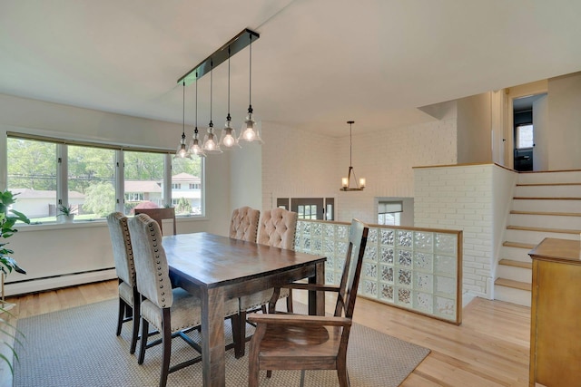 24 Harvard Ln, Commack, NY 11725 - dining room with light wood-style floors, a baseboard radiator, a chandelier, and stairway