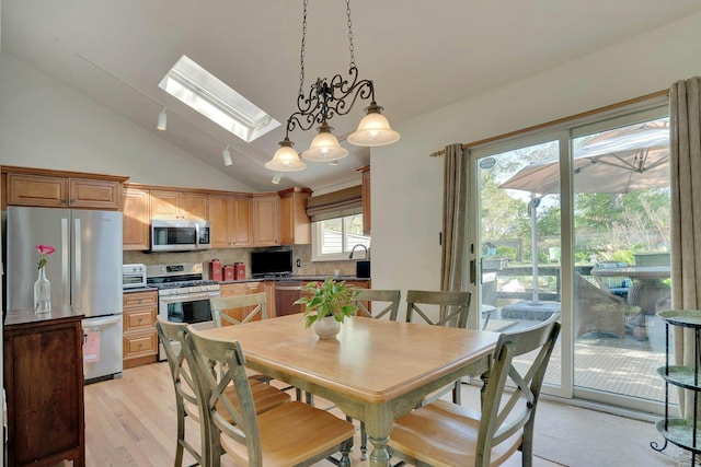 24 Harvard Ln, Commack, NY 11725 - dining room with a skylight, lofted ceiling, and light wood-type flooring
