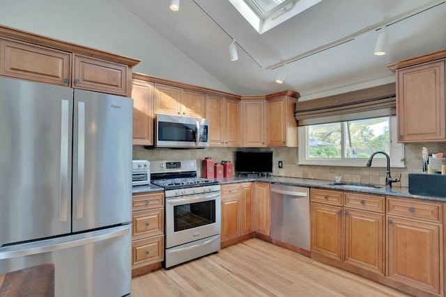24 Harvard Ln, Commack, NY 11725 - kitchen featuring stainless steel appliances, a sink, lofted ceiling, dark stone counters, and rail lighting
