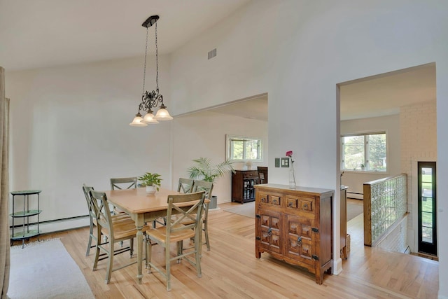 24 Harvard Ln, Commack, NY 11725 - dining room with a baseboard radiator, light wood-style floors, and a high ceiling