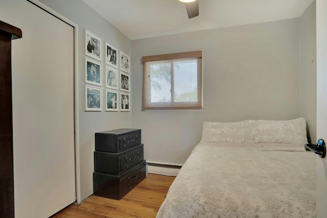 24 Harvard Ln, Commack, NY 11725 - bedroom featuring a baseboard radiator, light wood-type flooring, ceiling fan, and baseboards