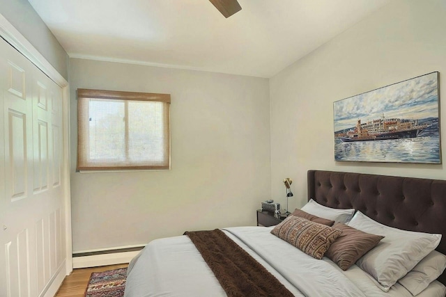 24 Harvard Ln, Commack, NY 11725 - bedroom with a baseboard radiator, wood finished floors, baseboards, and a ceiling fan