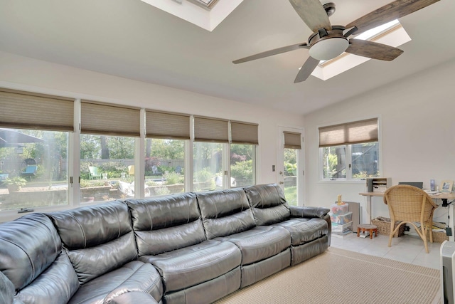 24 Harvard Ln, Commack, NY 11725 - living room with a ceiling fan, light tile patterned floors, a skylight, and vaulted ceiling