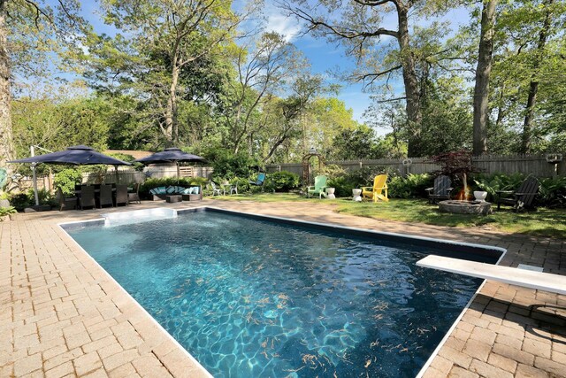 24 Harvard Ln, Commack, NY 11725 - view of swimming pool with a fenced backyard, a patio area, a fire pit, and a diving board
