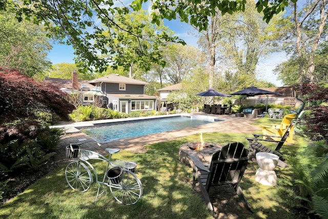 24 Harvard Ln, Commack, NY 11725 - outdoor pool featuring a fire pit, a patio area, and a lawn