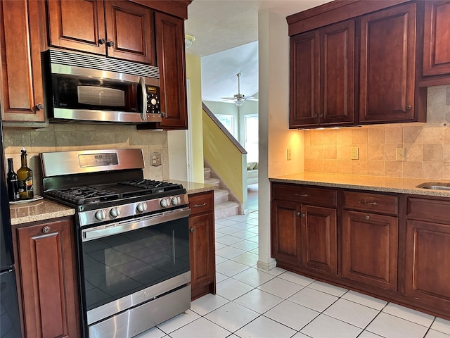 1 Olde Wagon Rd, Warwick, NY 10990 - kitchen with appliances with stainless steel finishes, tasteful backsplash, light tile patterned floors, ceiling fan, and light stone counters