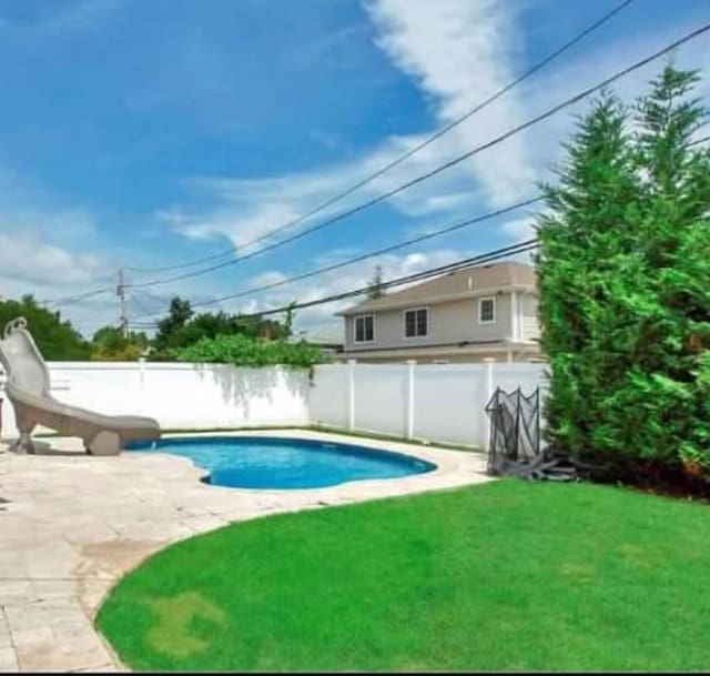 view of pool featuring a water slide and a patio area