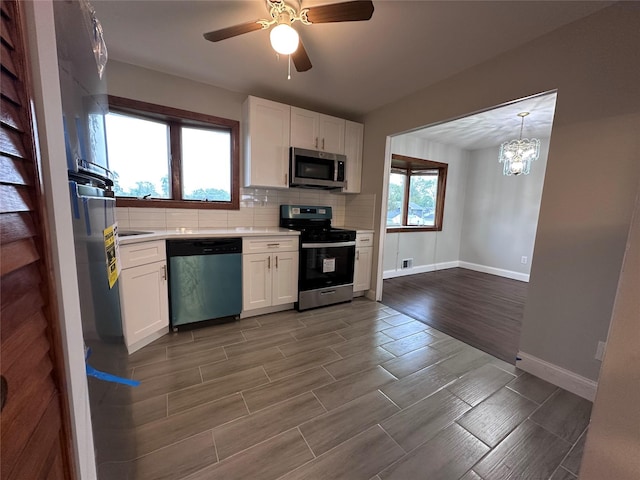 42 Blacker St, Brentwood, NY 11717 - kitchen with appliances with stainless steel finishes, light countertops, baseboards, and white cabinetry