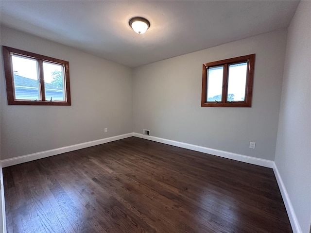 42 Blacker St, Brentwood, NY 11717 - spare room with plenty of natural light, dark wood finished floors, and baseboards