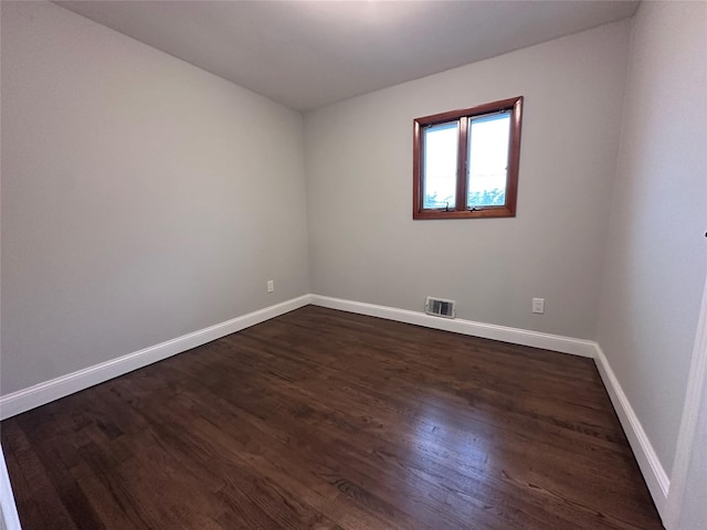 42 Blacker St, Brentwood, NY 11717 - spare room featuring dark wood-type flooring and baseboards