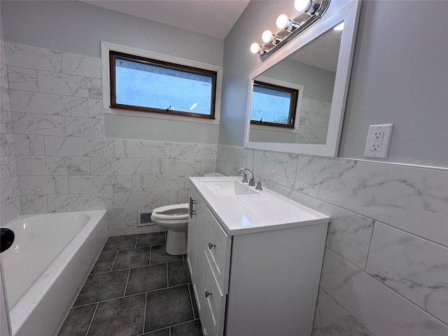 42 Blacker St, Brentwood, NY 11717 - bathroom featuring tile walls, vanity, a bathtub, tile patterned flooring, and wainscoting