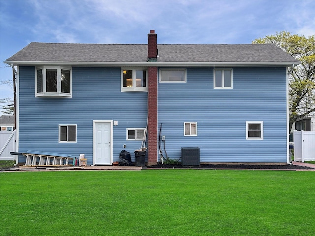 42 Blacker St, Brentwood, NY 11717 - rear view of house featuring a chimney and central AC unit