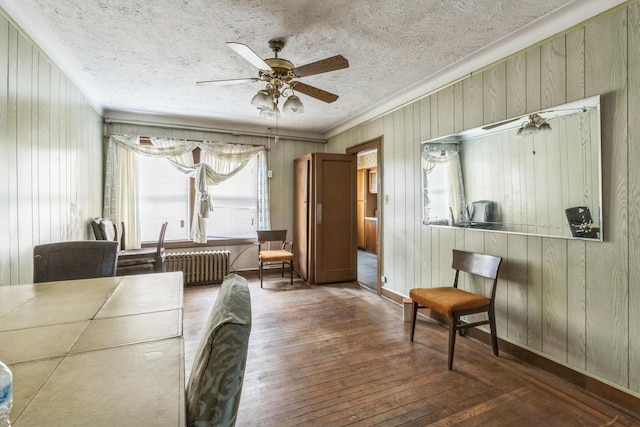 179-03 Selover Rd, Jamaica, NY 11434 - dining room featuring crown molding, hardwood / wood-style floors, ceiling fan, radiator heating unit, and wooden walls