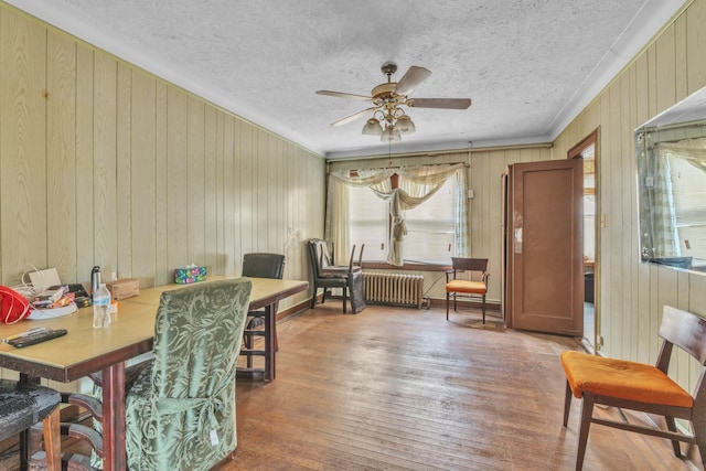 179-03 Selover Rd, Jamaica, NY 11434 - dining room with radiator, healthy amount of natural light, ceiling fan, crown molding, and wood walls