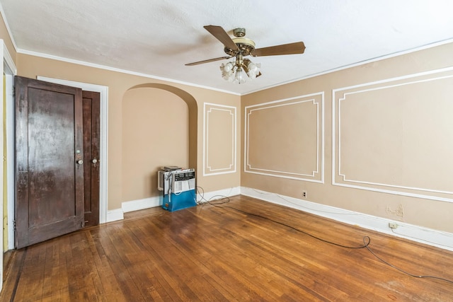 179-03 Selover Rd, Jamaica, NY 11434 - unfurnished room featuring a ceiling fan, wood-type flooring, arched walkways, baseboards, and crown molding