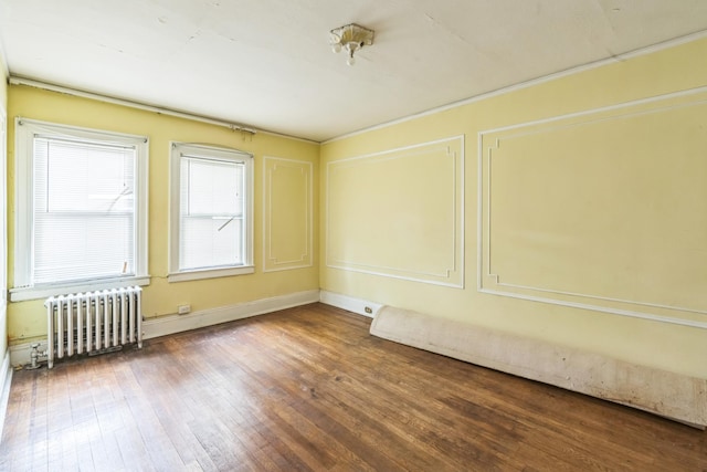 179-03 Selover Rd, Jamaica, NY 11434 - spare room with radiator, wood-type flooring, and baseboards