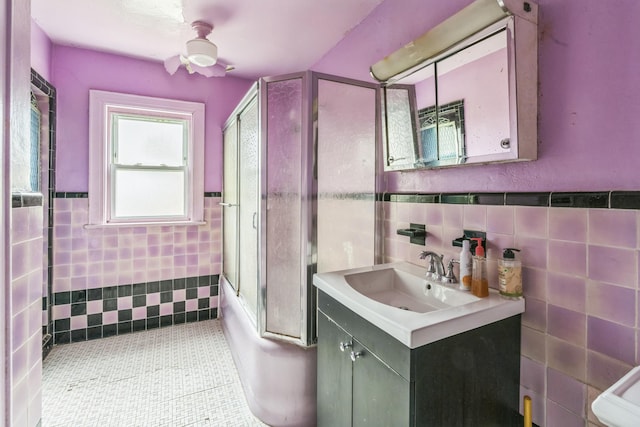 179-03 Selover Rd, Jamaica, NY 11434 - full bathroom featuring tile walls, bath / shower combo with glass door, vanity, toilet, and wainscoting