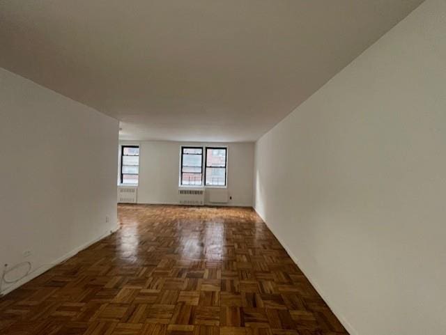 108-49 63rd Dr Unit 1K, Forest Hills, NY 11375 - spare room featuring radiator and baseboards