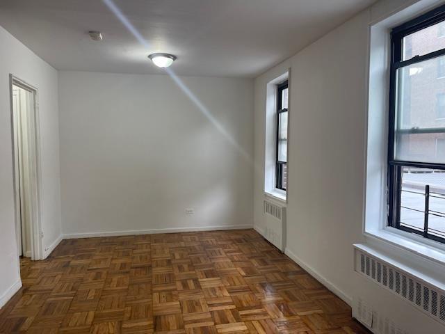 108-49 63rd Dr Unit 1K, Forest Hills, NY 11375 - unfurnished room featuring radiator