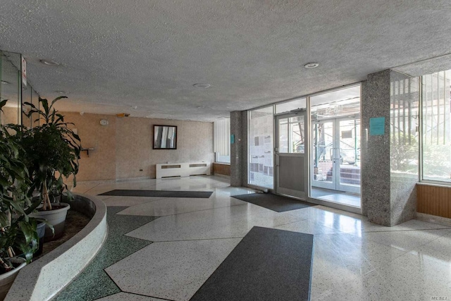 108-49 63rd Dr Unit 1K, Forest Hills, NY 11375 - community lobby featuring a textured ceiling and expansive windows