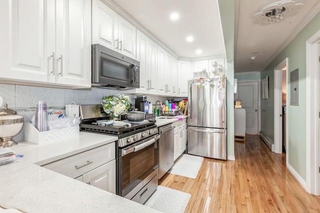 23118 145th Ave, Springfield Gardens, NY 11413 - kitchen with appliances with stainless steel finishes, white cabinetry, a sink, light wood-style flooring, and recessed lighting