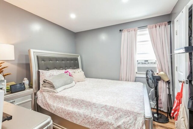 23118 145th Ave, Springfield Gardens, NY 11413 - bedroom with cooling unit, wood finished floors, and recessed lighting