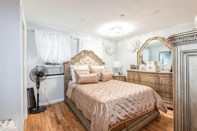 23118 145th Ave, Springfield Gardens, NY 11413 - bedroom with wood finished floors, cooling unit, and baseboards