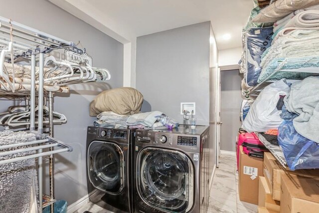 23118 145th Ave, Springfield Gardens, NY 11413 - washroom with washer and clothes dryer and marble look tiles
