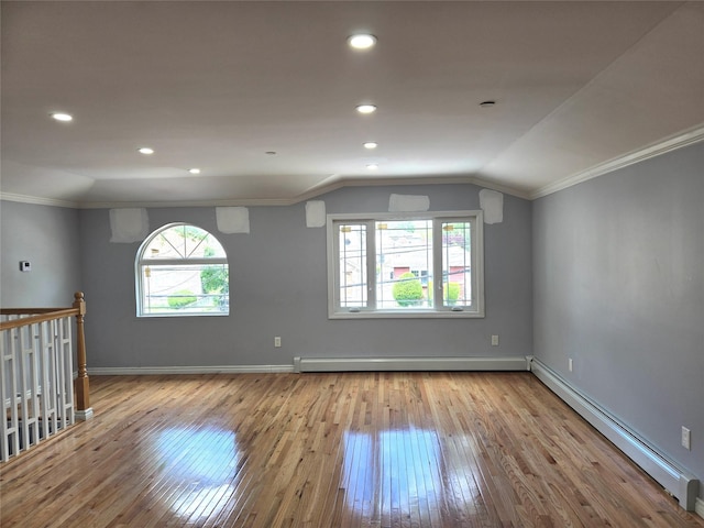 23118 145th Ave, Springfield Gardens, NY 11413 - spare room featuring a baseboard heating unit, wood-type flooring, plenty of natural light, vaulted ceiling, and crown molding