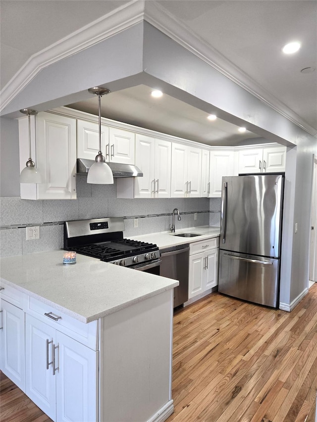 23118 145th Ave, Springfield Gardens, NY 11413 - kitchen with stainless steel appliances, ornamental molding, white cabinetry, a sink, and light wood finished floors