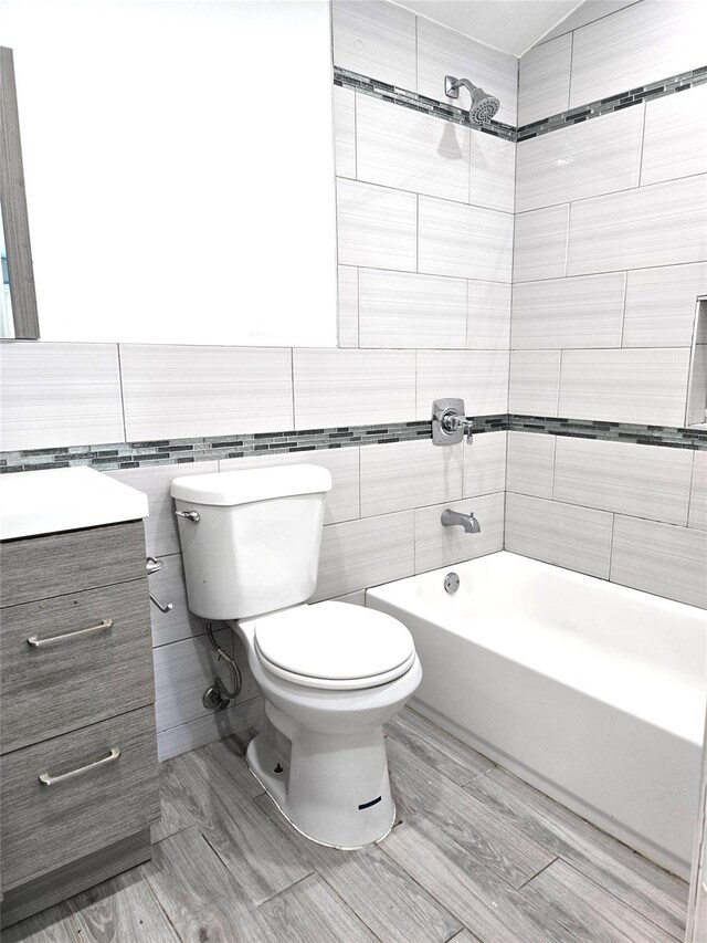 23118 145th Ave, Springfield Gardens, NY 11413 - bathroom featuring toilet, shower / tub combination, vanity, and tile walls