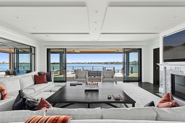 34 Westbridge Rd, Westhampton Beach, NY 11978 - living area with a water view, wood finished floors, a high end fireplace, and plenty of natural light