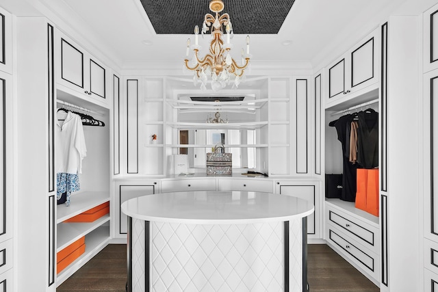 34 Westbridge Rd, Westhampton Beach, NY 11978 - walk in closet featuring a chandelier and dark wood-type flooring