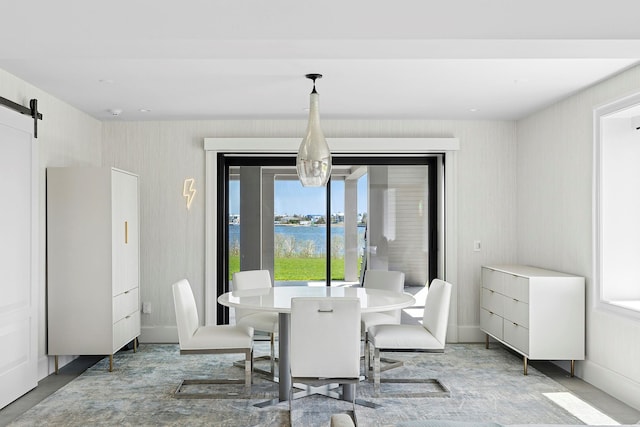 34 Westbridge Rd, Westhampton Beach, NY 11978 - dining area with a water view, a barn door, and wallpapered walls