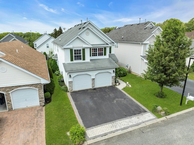 7 Marisa Dr, Middle Island, NY 11953 - traditional home featuring stone siding, driveway, an attached garage, and a front yard