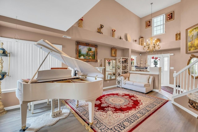 7 Marisa Dr, Middle Island, NY 11953 - living area featuring a towering ceiling, a chandelier, wood finished floors, and baseboards